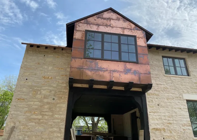 Copper metal panel facade on a stone building for Skylight Installation in North Arlington